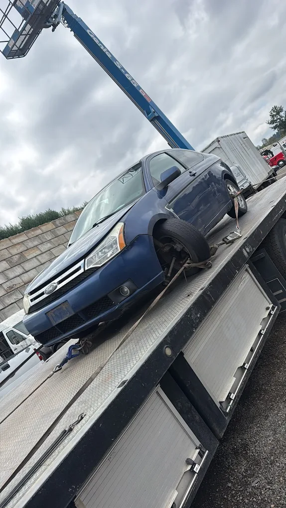 Cash for scrap cars being loaded onto a tow truck in Surrey